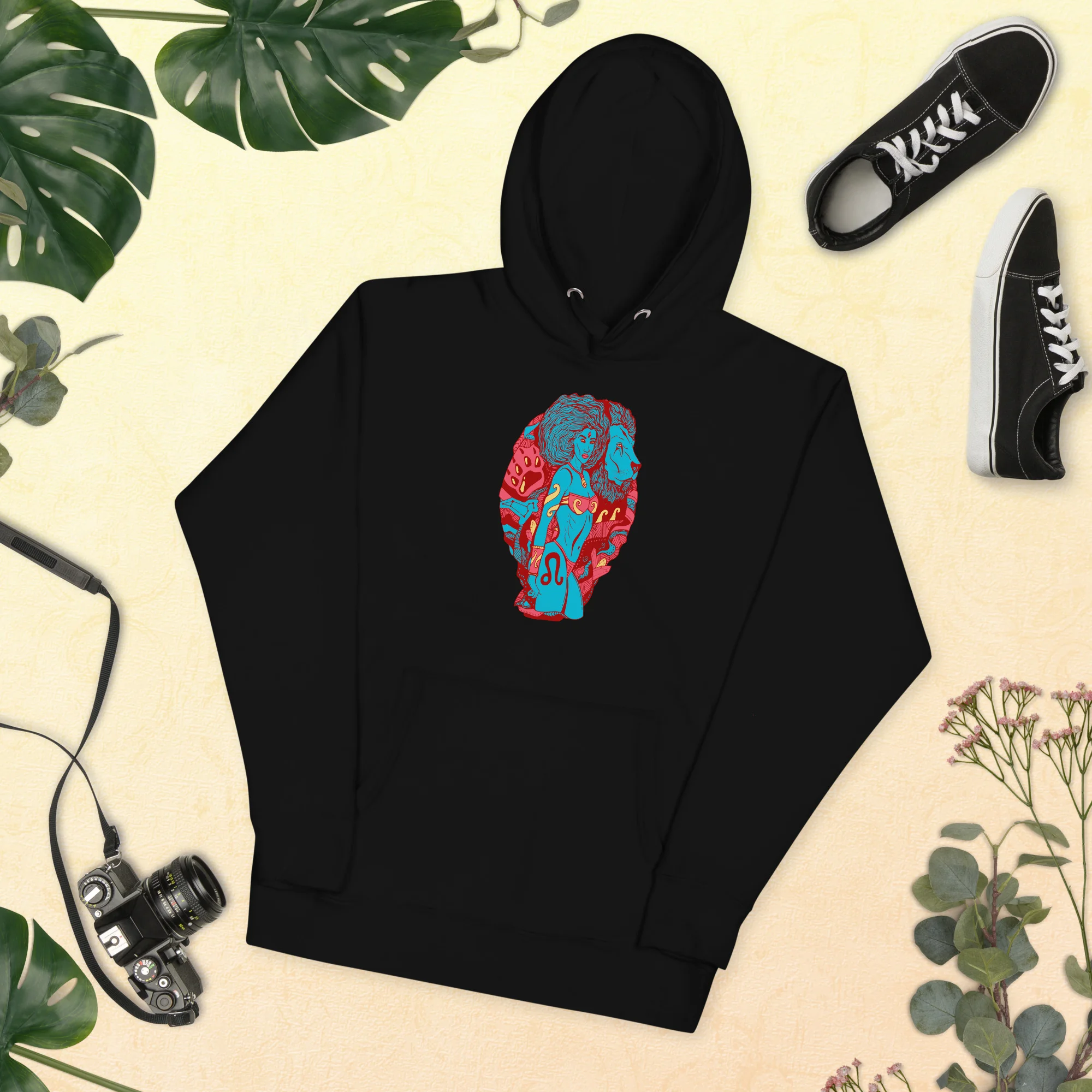 Black leo hoodie with red and blue zodiac artwork displayed flat on cream background
