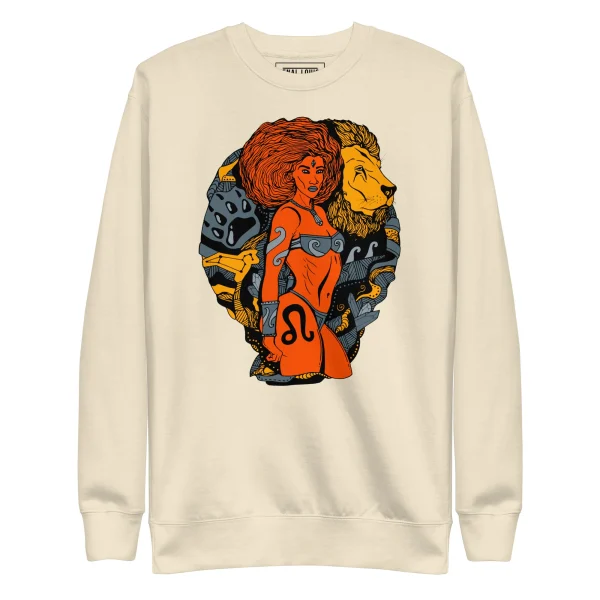 Bone-colored leo sweatshirt featuring orange and gold artwork of a woman with red hair flanked by warrior and lion figures
