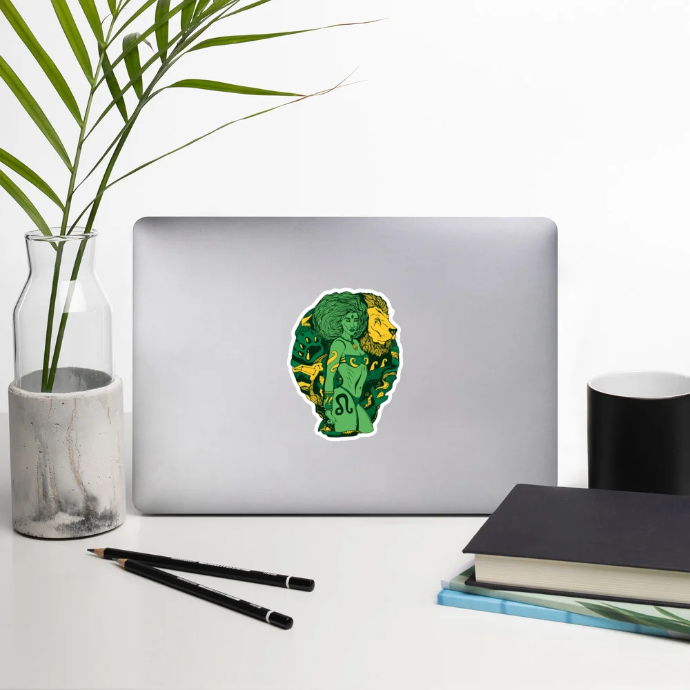 Green and gold Leo zodiac sticker with Amazonian warrior design displayed on silver laptop lid