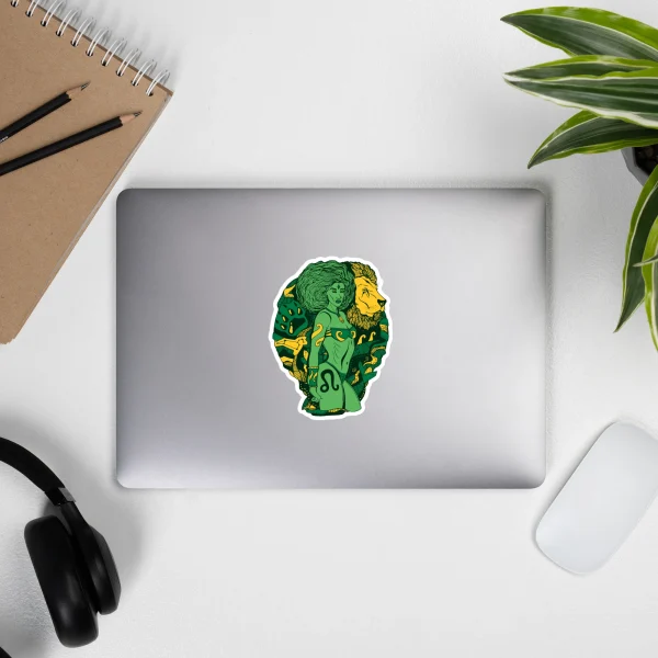 Leo zodiac sticker featuring green Amazonian warrior design with gold accents on silver laptop
