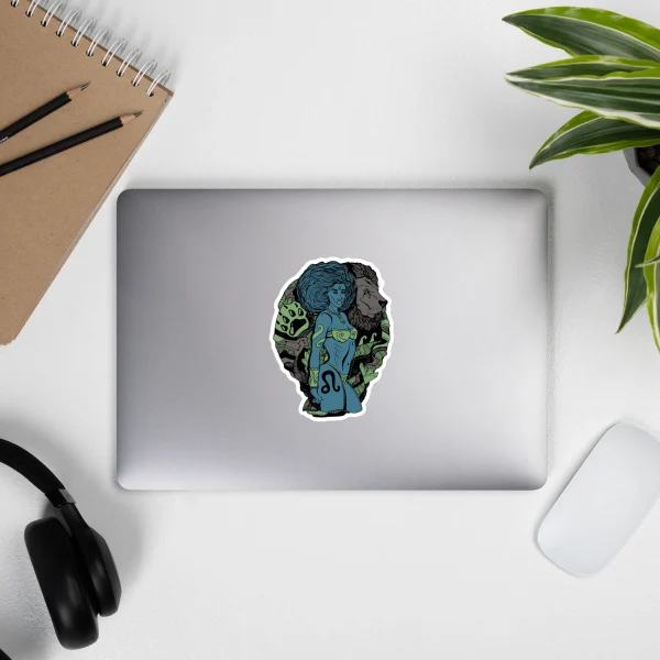 Leo zodiac sticker featuring blue and green Amazonian warrior artwork on silver laptop