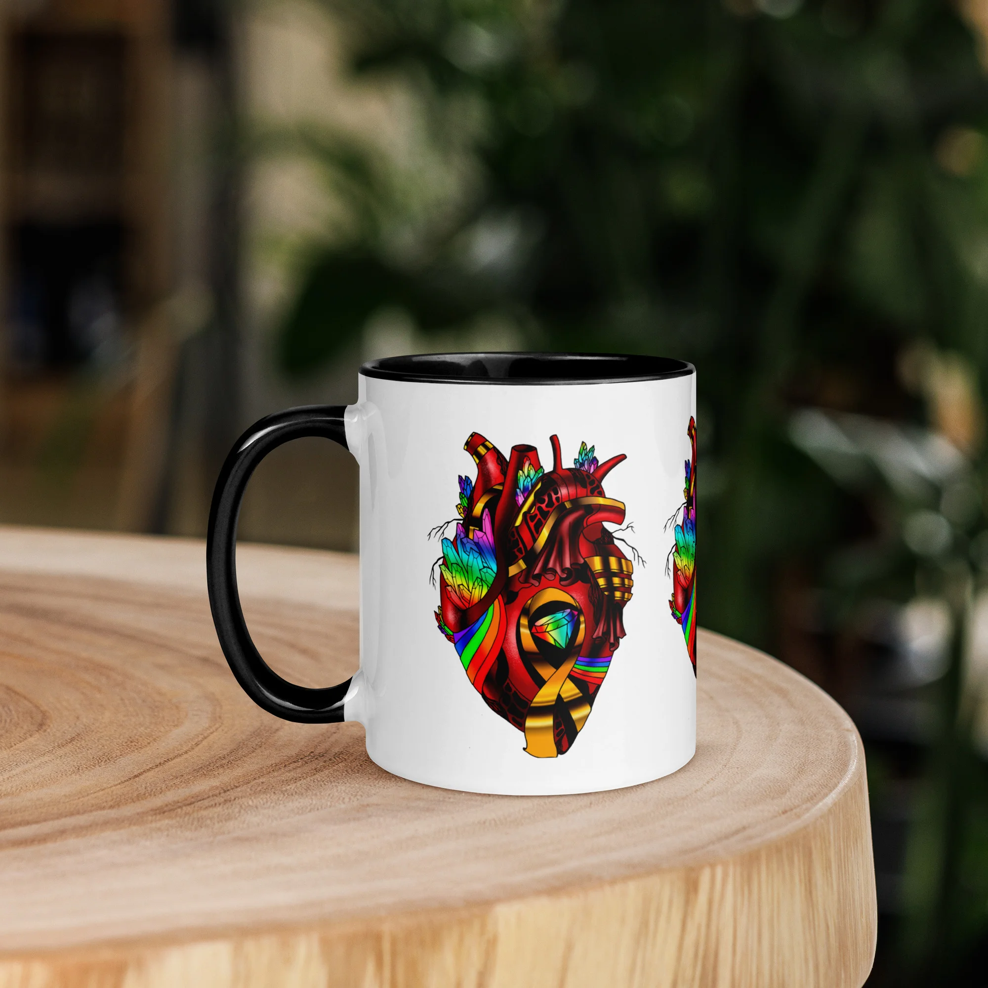 Colorful rainbow heart design on white LGBTQ coffee mug with black handle, displayed on wooden table