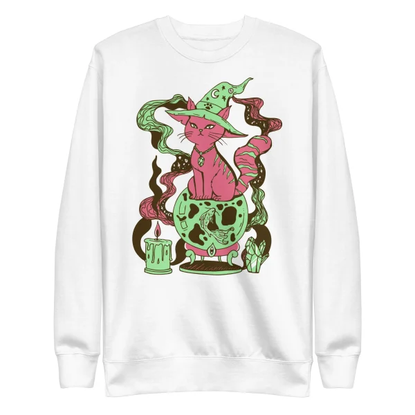 Pink and green magical cat sweatshirt featuring a fortune cat witch with mystical elements and skull cauldron on white crew-neck