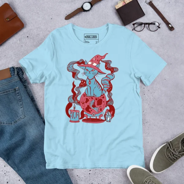 Pastel blue magical cat t-shirt featuring a red fortune cat design with mystical elements, displayed flat with accessories