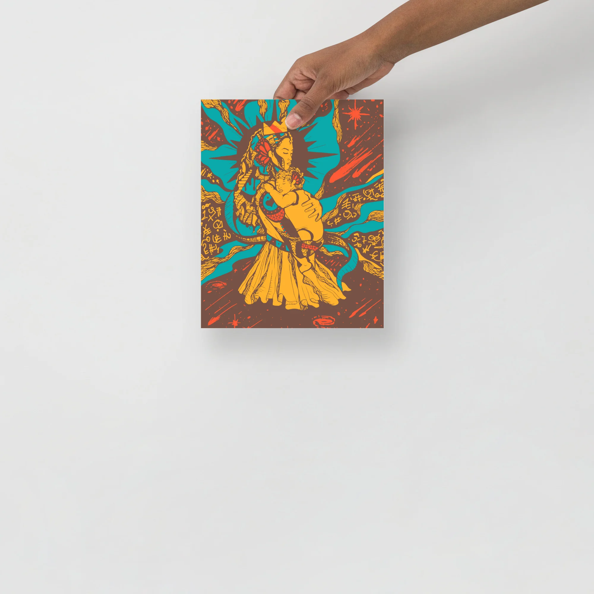 Hand holding a vibrant moon wall art print featuring a golden mother figure against turquoise and orange celestial background
