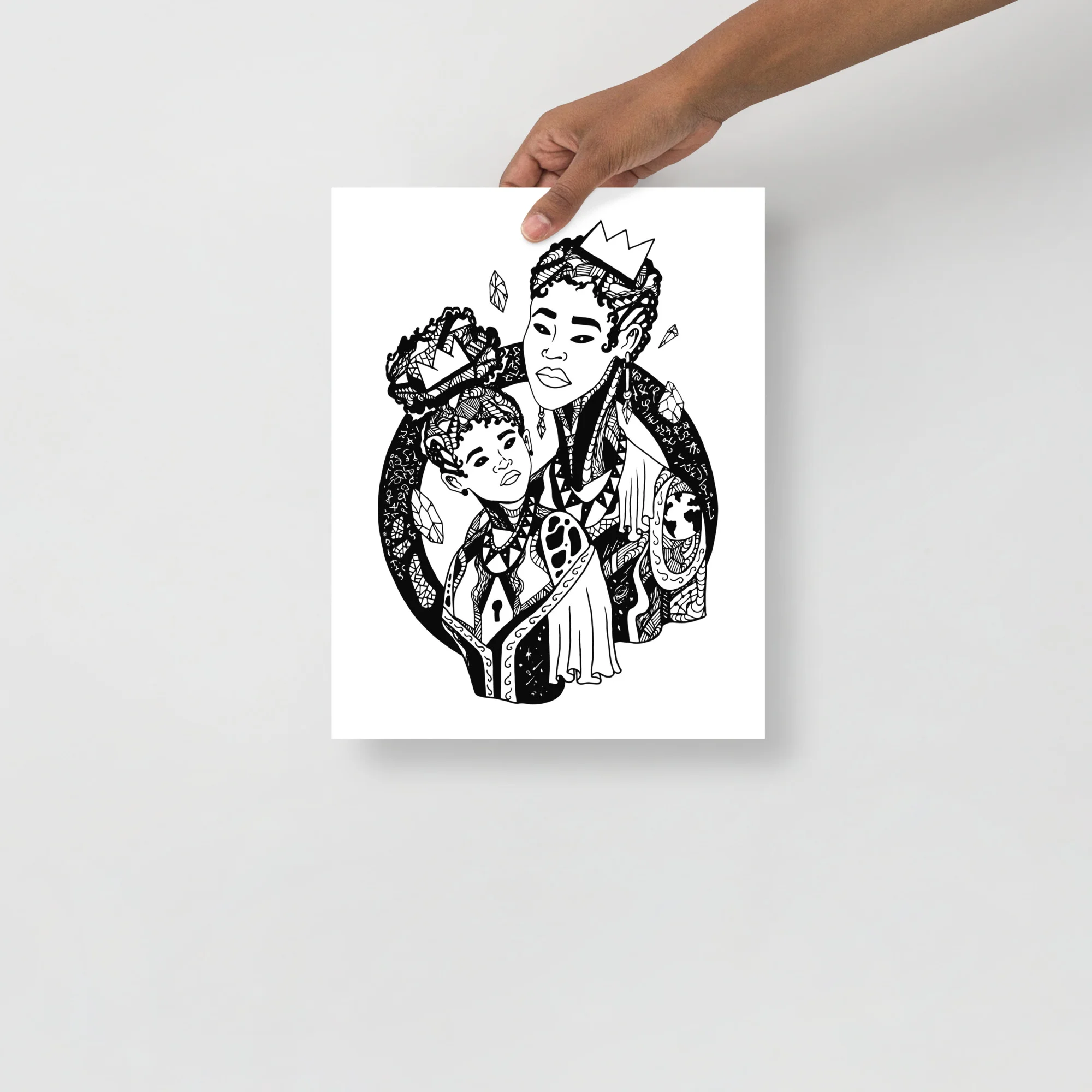Mother and child art print featuring Venus and Star design in black ink on white paper, held by hand