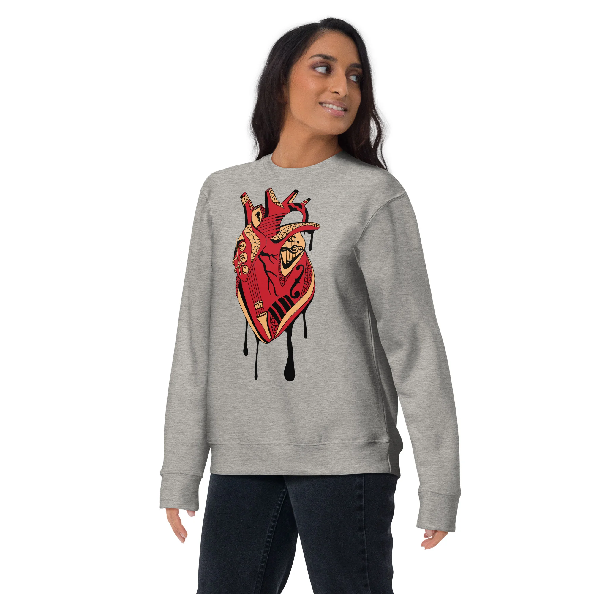 Woman wearing a grey musical heart sweatshirt with red and cream artwork design featuring a decorative anatomical heart.