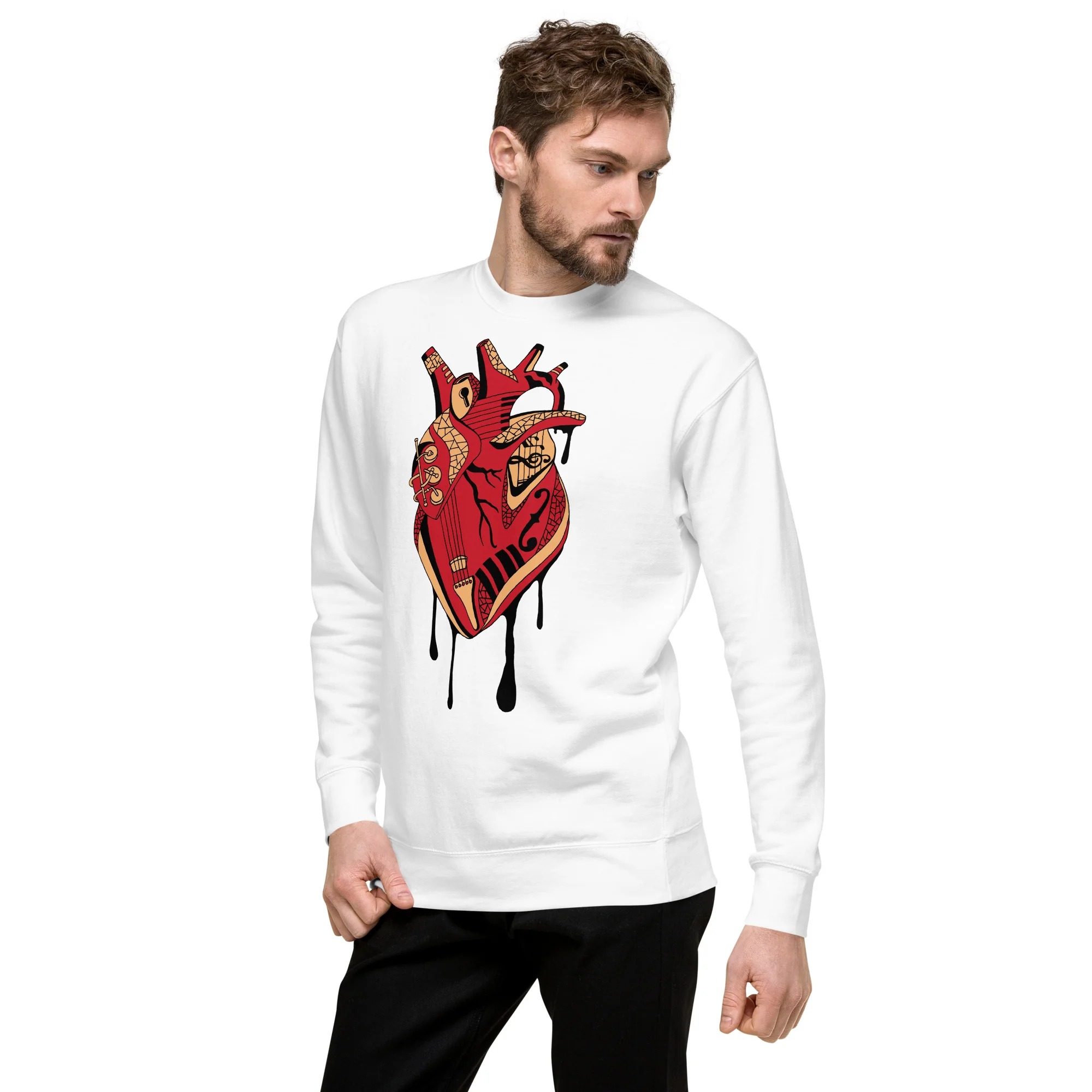 Man wearing a white musical heart sweatshirt with red and gold anatomical heart design featuring ornate patterns and dripping details.