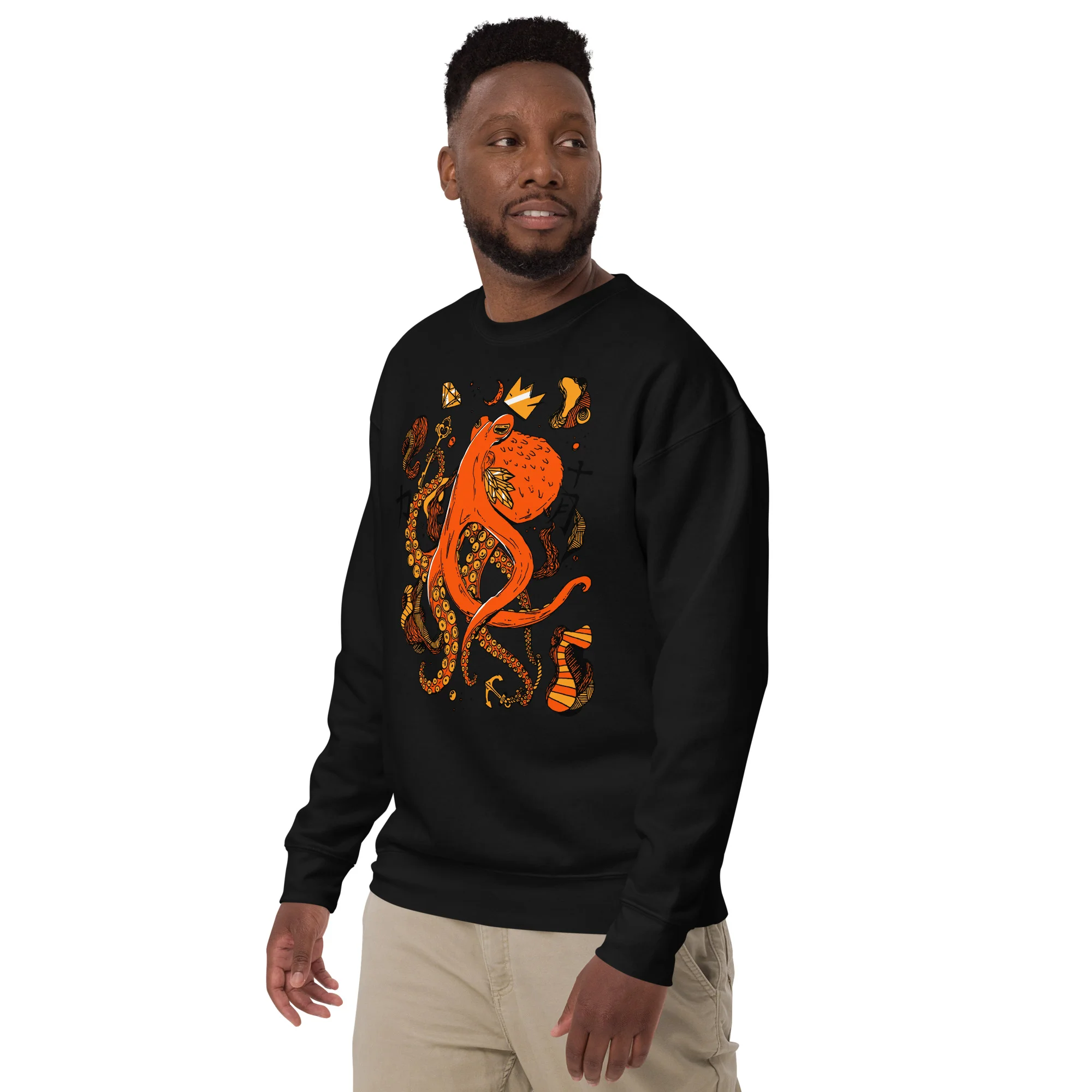 Man wearing black octopus sweatshirt with orange and gold abstract design, crew neck style