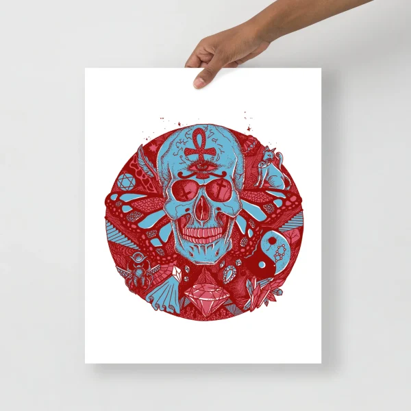 Pastel blue skull art print with red decorative elements and intricate circular patterns held by a hand