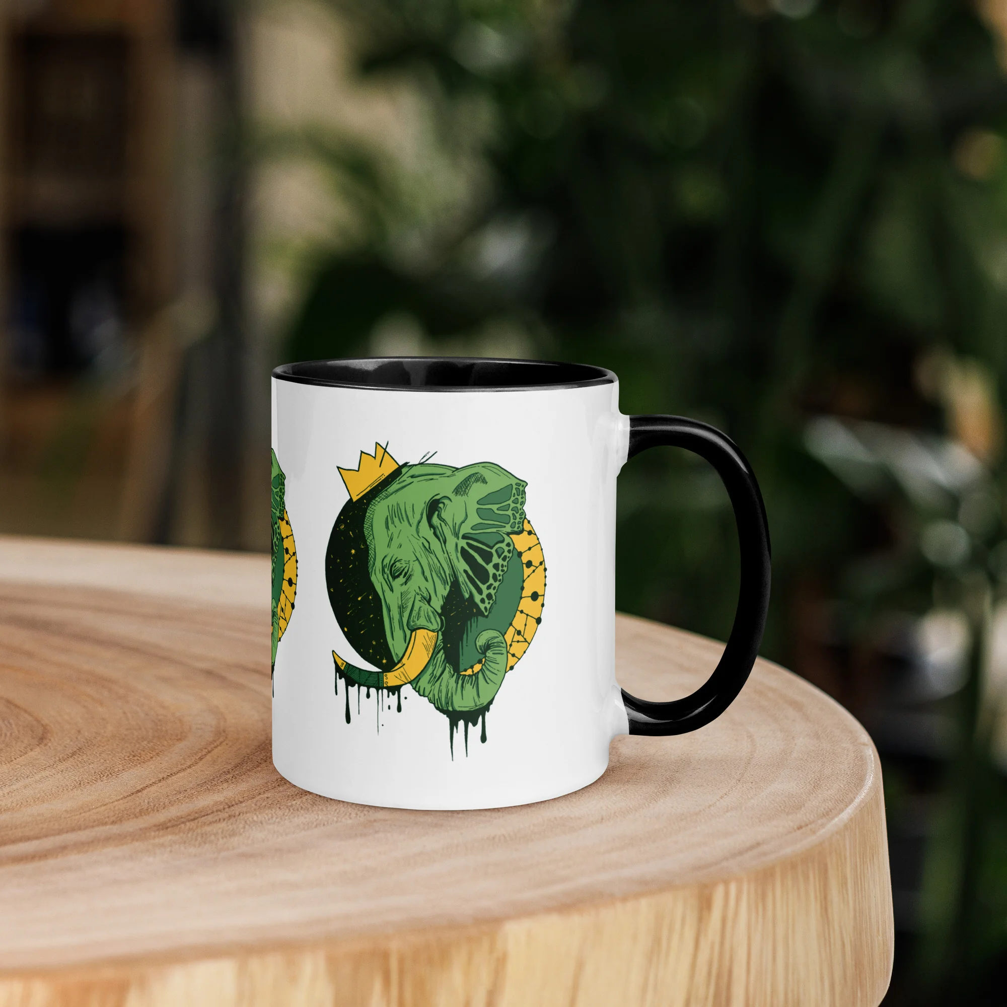 Colorful ceramic elephant mug featuring a royal crown illustration drawing by Kenal Louis, with tinted rim, handle, and interior