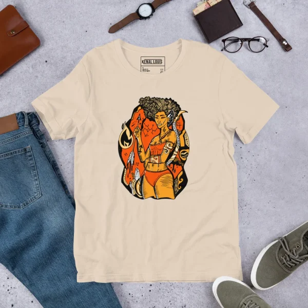 Cream sagittarius t-shirt featuring a black and orange goddess illustration with gold accents, displayed flat lay with accessories.