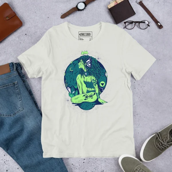 Cream-colored scorpio goddess shirt with vibrant green and teal zodiac artwork displayed flat with accessories