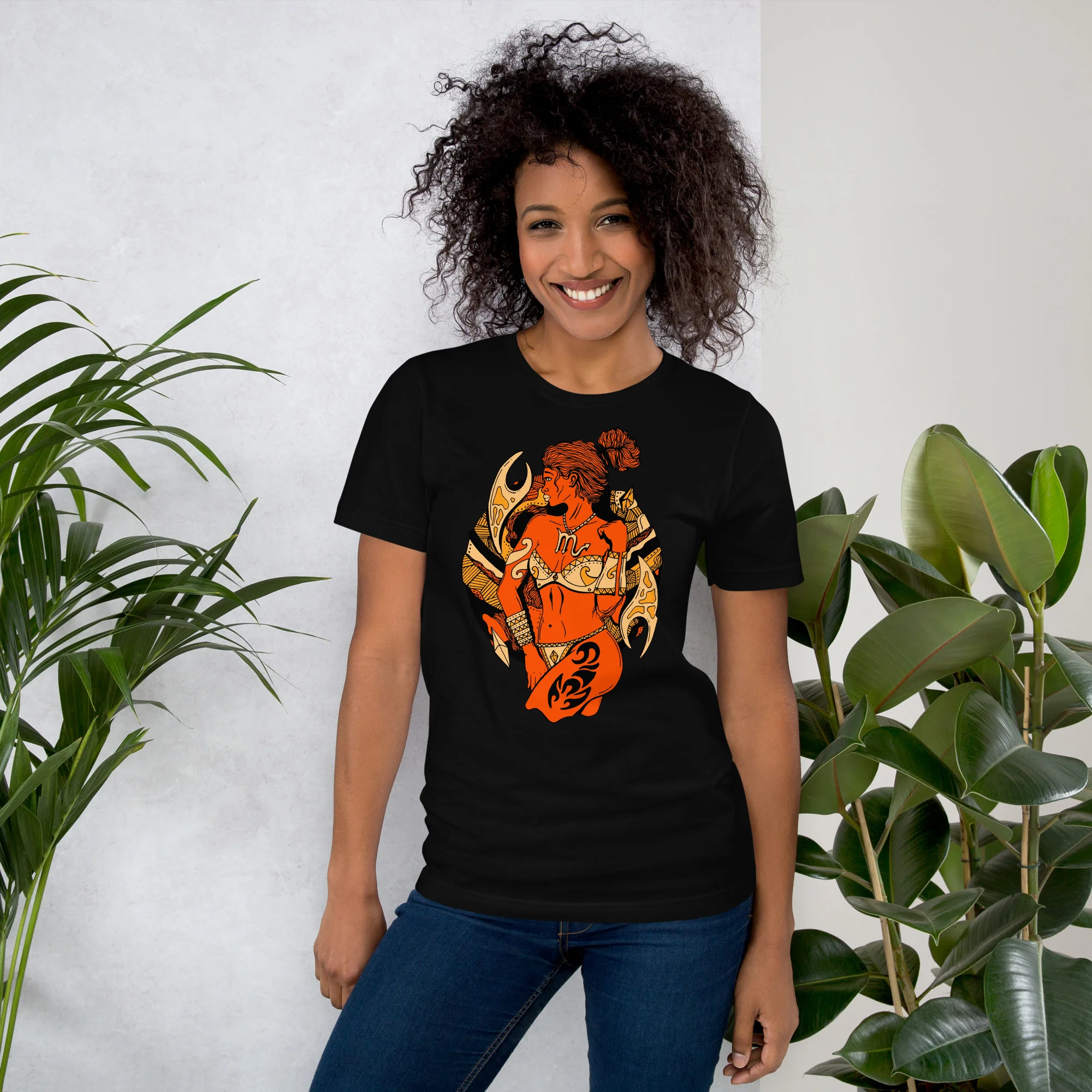 Woman wearing black scorpio t-shirt with orange and gold warrior artwork design