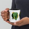 Colorful ceramic elephant mug featuring a royal crown illustration drawing by Kenal Louis, with tinted rim, handle, and interior