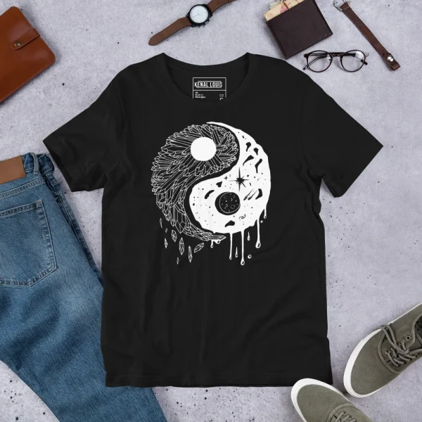 Black yin yang t-shirt with white crystal night sky line art design and celestial elements displayed flat with accessories
